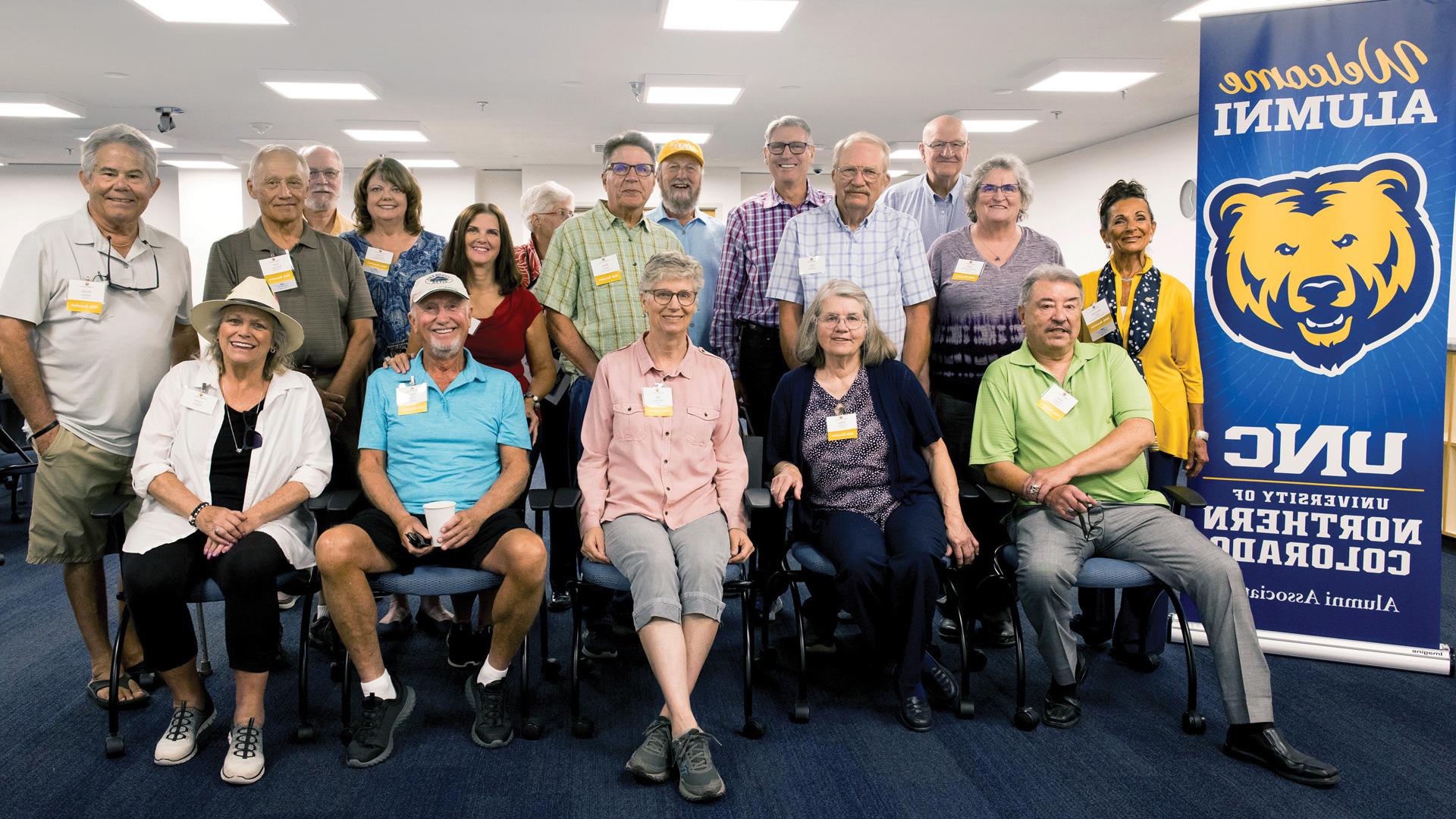 The class of 1975 stand together for a photo at their 50 year class reunion.